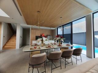 Elegant dining room with pool view and modern decor