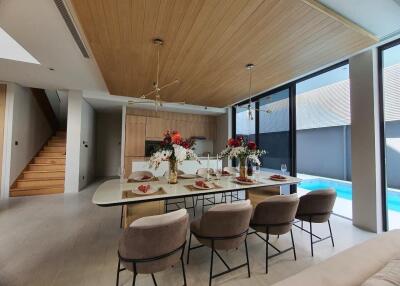 Elegant dining room with pool view and modern decor