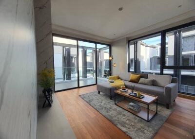 Modern and spacious living room with large windows and stylish decor