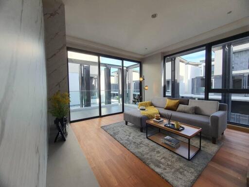 Modern and spacious living room with large windows and stylish decor