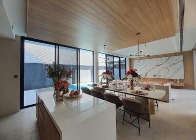 Modern kitchen with marble countertop and wooden ceiling