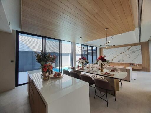 Modern kitchen with marble countertop and wooden ceiling