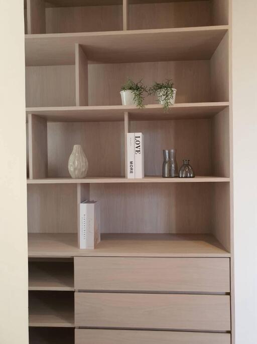 Modern wooden bookshelf in a living room with minimalistic decor