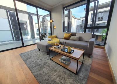 Spacious and modern living room with large windows and comfortable seating