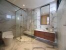 Modern bathroom with marble tiles and glass shower