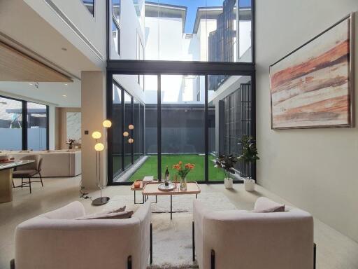 Spacious and modern living room with large windows and outdoor view