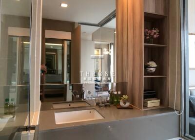 Modern bathroom with elegant fixtures and wooden accents