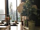 Elegant kitchen counter with flowers arrangement and cityscape view