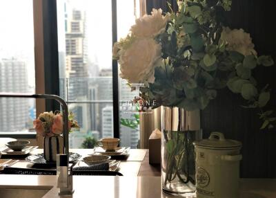 Elegant kitchen counter with flowers arrangement and cityscape view