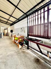 Spacious industrial space with workbench and storage units