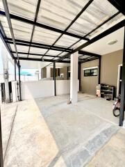 Spacious, well-lit garage with metal roofing and ample storage space