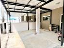 Spacious, well-lit garage with metal roofing and ample storage space