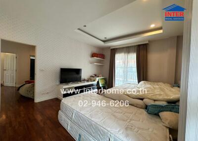 Spacious bedroom with integrated living area, featuring modern furnishings and natural light