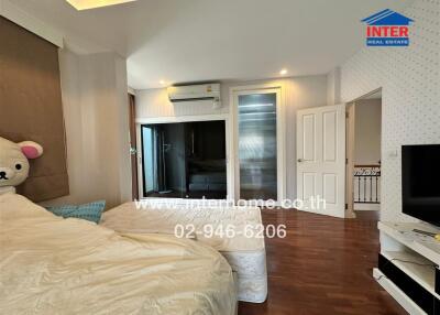 Spacious bedroom with modern amenities and natural lighting