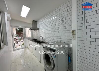 Modern kitchen with white subway tiles and marble flooring