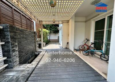 Spacious wood-deck patio with bicycles and exterior lighting