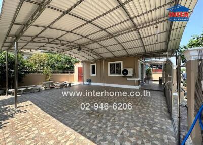 Spacious covered outdoor patio area with seating and ample shade