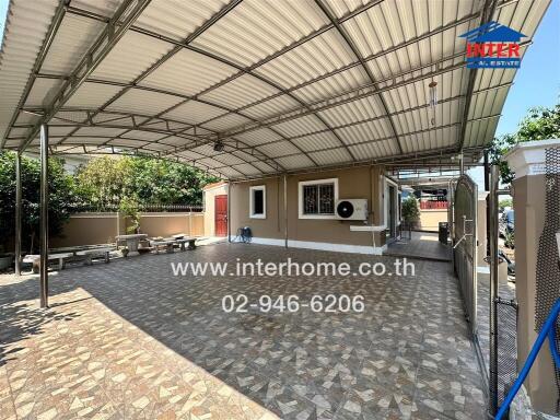 Spacious covered outdoor patio area with seating and ample shade