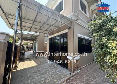 Spacious and well-maintained house exterior with paving and carport