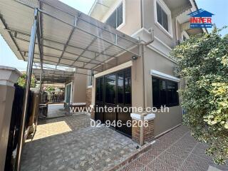 Spacious and well-maintained house exterior with paving and carport