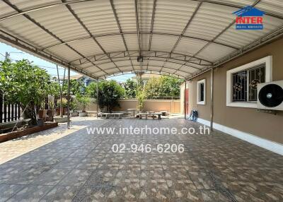 Spacious covered patio with outdoor seating and tiled flooring