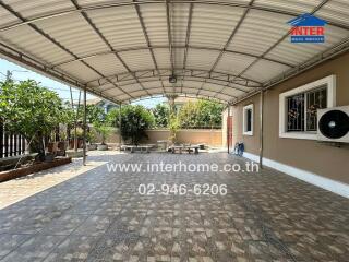 Spacious covered patio with outdoor seating and tiled flooring