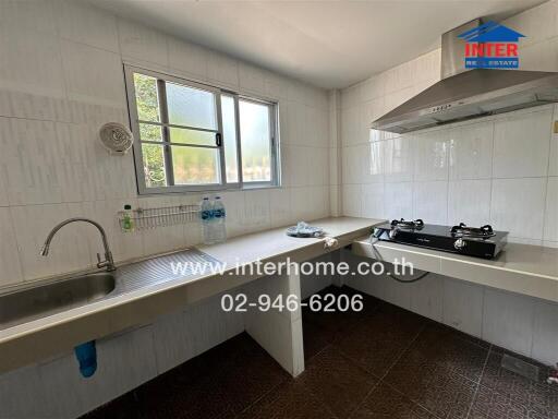 Bright kitchen with large window and modern appliances