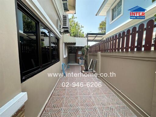 Spacious and well-maintained home exterior with tiled pathway