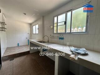 Spacious kitchen with large windows and extended counter space