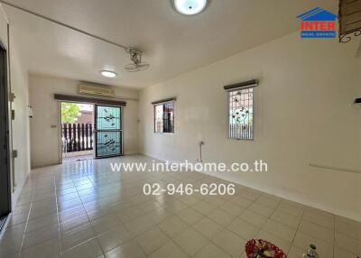 Bright and spacious living room with tiled flooring and access to balcony