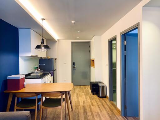 Modern kitchen with dining area in a well-lit apartment