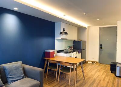 Modern kitchen with blue accent wall and dining area