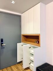 Modern entryway with built-in storage cabinets and wooden detailing