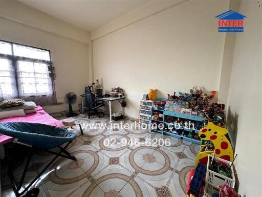 Spacious bedroom with decorative floor tiles and large window