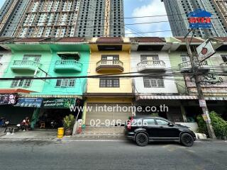 Urban multi-story building facade with commercial shops on ground floor