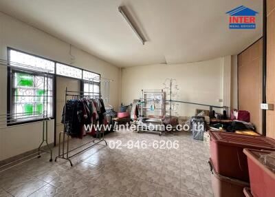 Spacious multipurpose room with tiled flooring and large windows