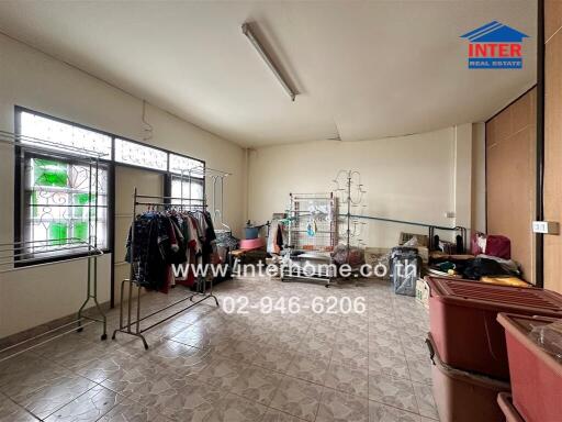 Spacious multipurpose room with tiled flooring and large windows