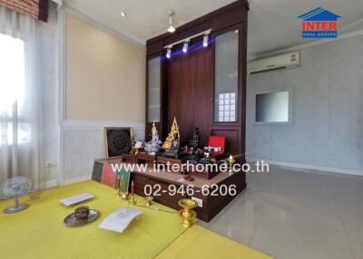 Spacious living room with religious altar and modern decor