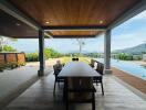 Elegant outdoor dining area with wooden roof and expansive view