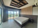 Spacious bedroom with wooden ceiling design and panoramic view