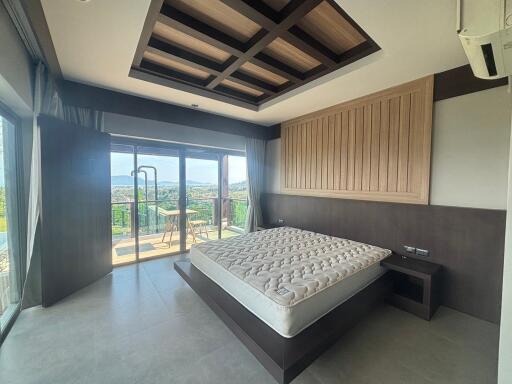 Spacious bedroom with wooden ceiling design and panoramic view