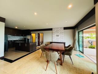 Spacious open plan kitchen with dining area featuring modern appliances and large windows
