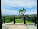 Patio view overlooking expansive garden and distant hills