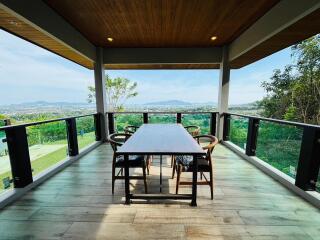 Spacious patio with panoramic view and wooden dining table