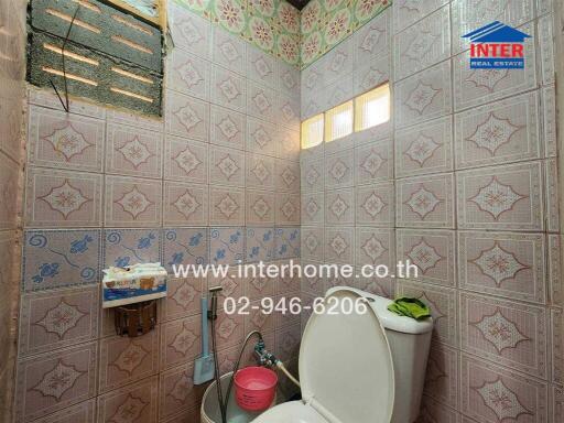 Spacious bathroom with decorative tiles and natural light