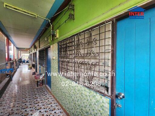 Colorful and vibrant entrance to a house with intricate metal gate and blue door