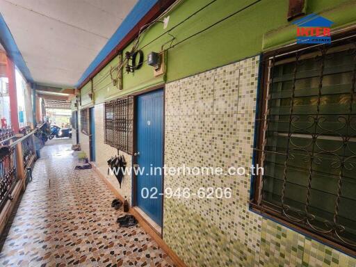 Colorful townhouse exterior with multiple doors and safety grills