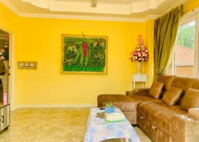 Bright and spacious living room with yellow walls and comfortable seating