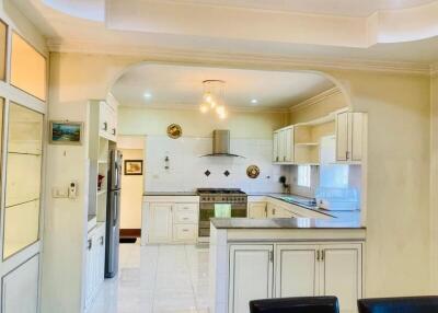Spacious and modern kitchen with white cabinetry and stainless steel appliances