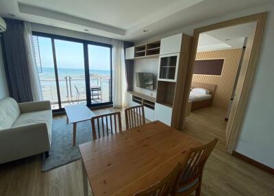 Spacious living room with ocean view and access to balcony